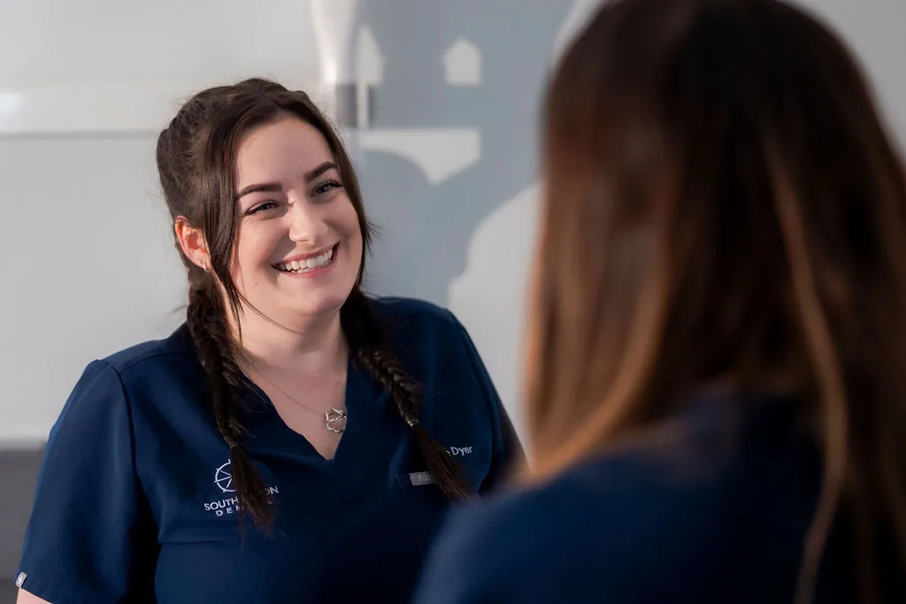 A relaxed conversation between a patient and a member of the dental team.